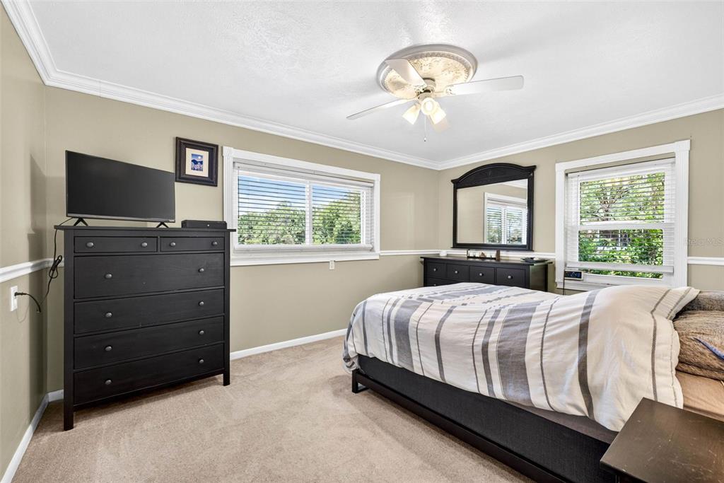 16330 Hanna Road Lutz, FL 33549 - Photo 20 of 41 a bedroom with a bed and a flat tv screen on dresser