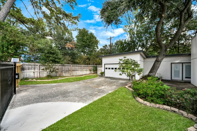 a view of a backyard with swimming pool