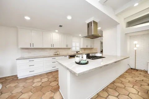 a kitchen with sink cabinets and stove