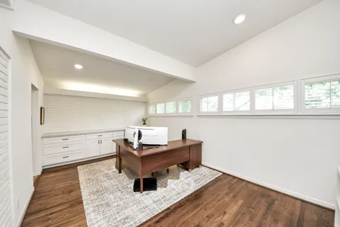 wooden floor with a window and furniture