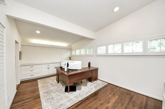 wooden floor with a window and furniture