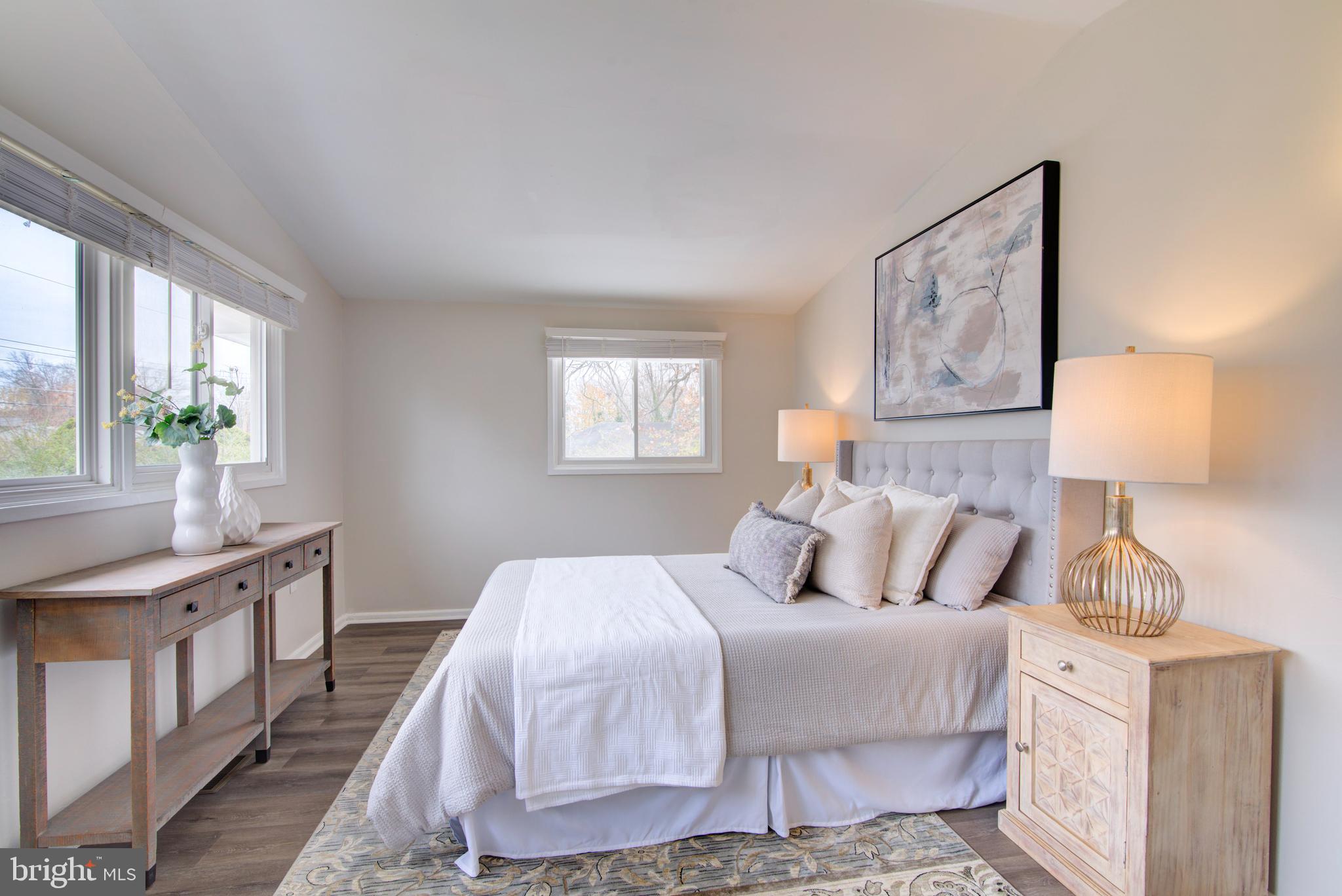 4103 Ivanhoe Lane Alexandria, VA 22310 - Photo 14 of 29 a bedroom with a bed and a lamp on dresser with a window