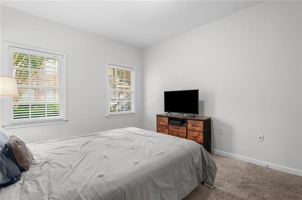 3675 Peachtree Road Northeast, Unit 45 Atlanta, GA 30319 - Photo 23 of 42 a bedroom with a bed and a flat screen tv