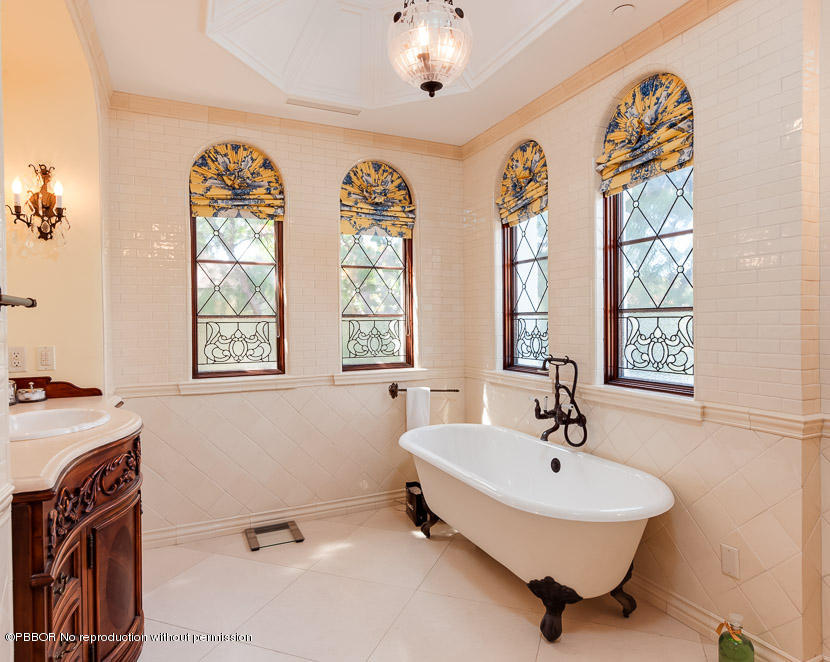102 Gulfstream Road, Unit A Palm Beach, FL 33480 - Photo 8 of 17 a bathroom with a tub sink and mirror
