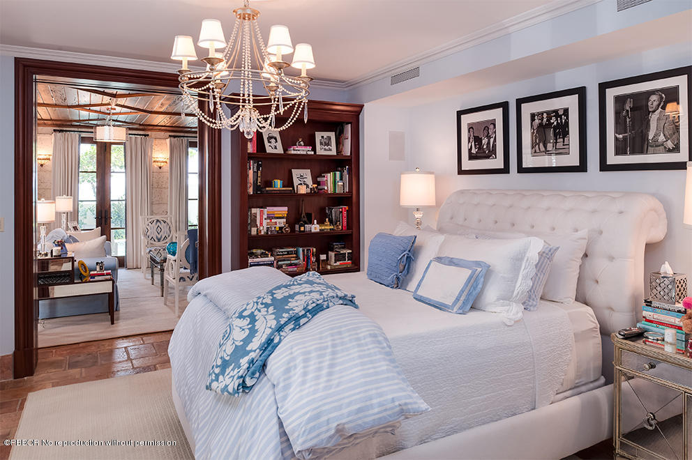 102 Gulfstream Road, Unit A Palm Beach, FL 33480 - Photo 10 of 17 a bedroom with a large bed and a chandelier