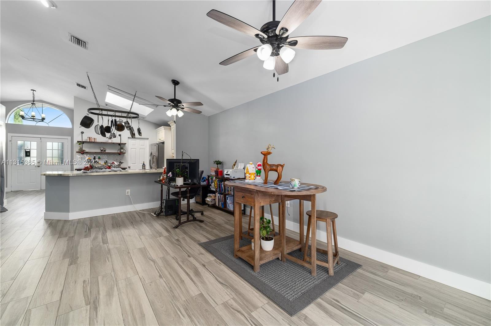 14626 Southwest 128th Court Road Miami, FL 33186 - Photo 11 of 24 a view of a dining room with furniture and wooden floor
