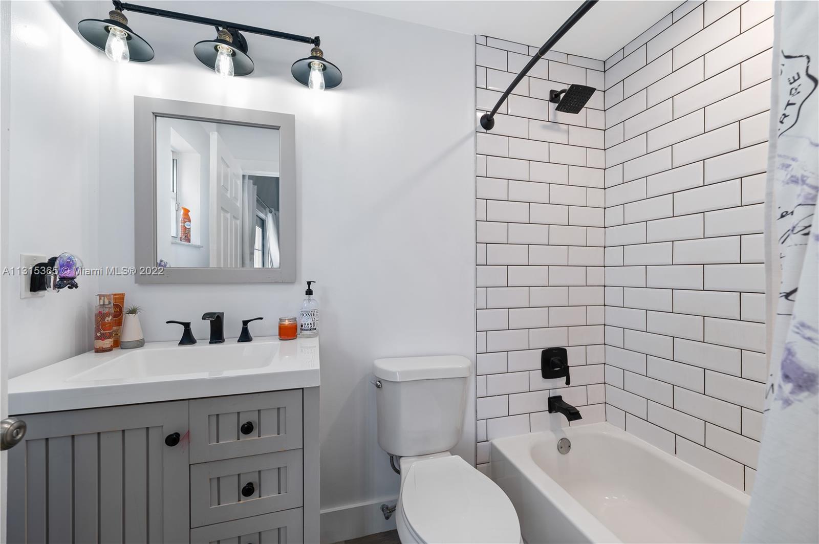 14626 Southwest 128th Court Road Miami, FL 33186 - Photo 14 of 24 a bathroom with a sink mirror toilet and vanity