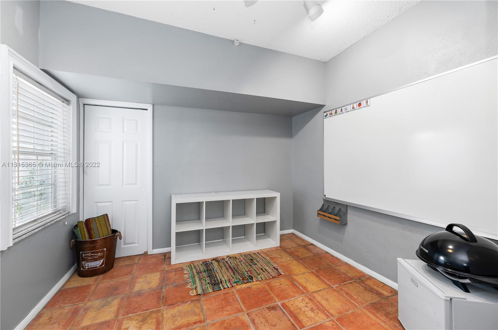 14626 Southwest 128th Court Road Miami, FL 33186 - Photo 18 of 24 a view of empty room with wooden floor and fan