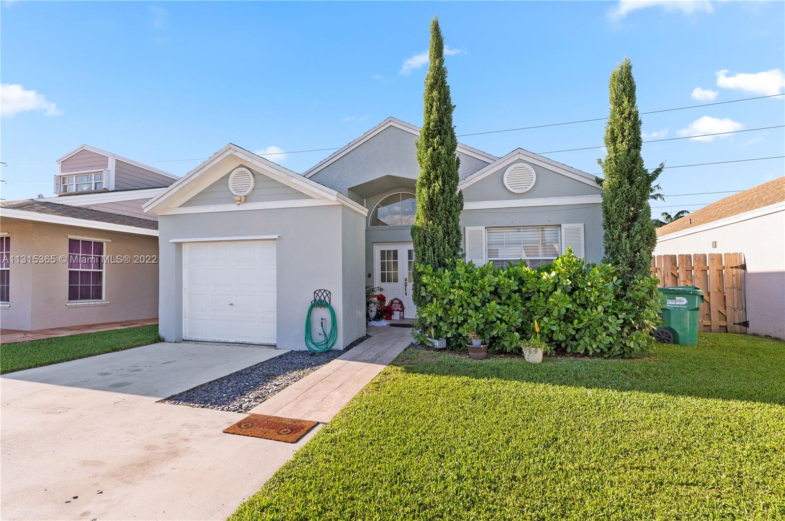 14626 Southwest 128th Court Road Miami, FL 33186 - Photo 2 of 24 a front view of a house with a yard and garage
