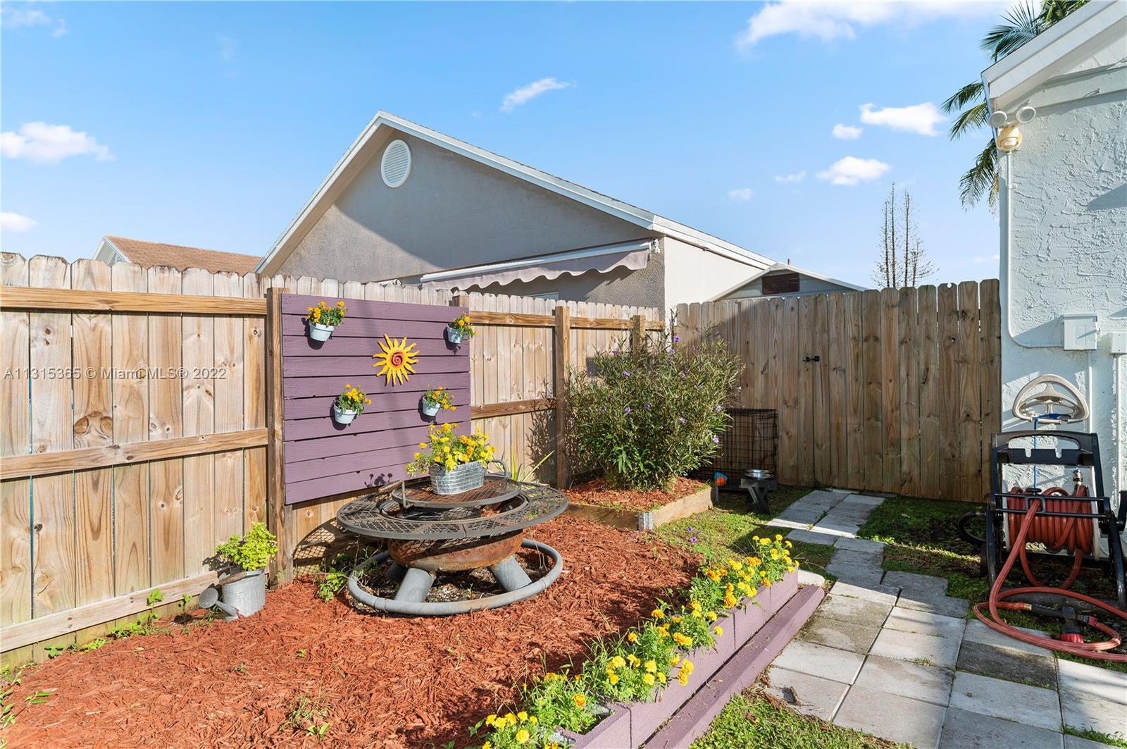 14626 Southwest 128th Court Road Miami, FL 33186 - Photo 23 of 24 a backyard of a house with seating space