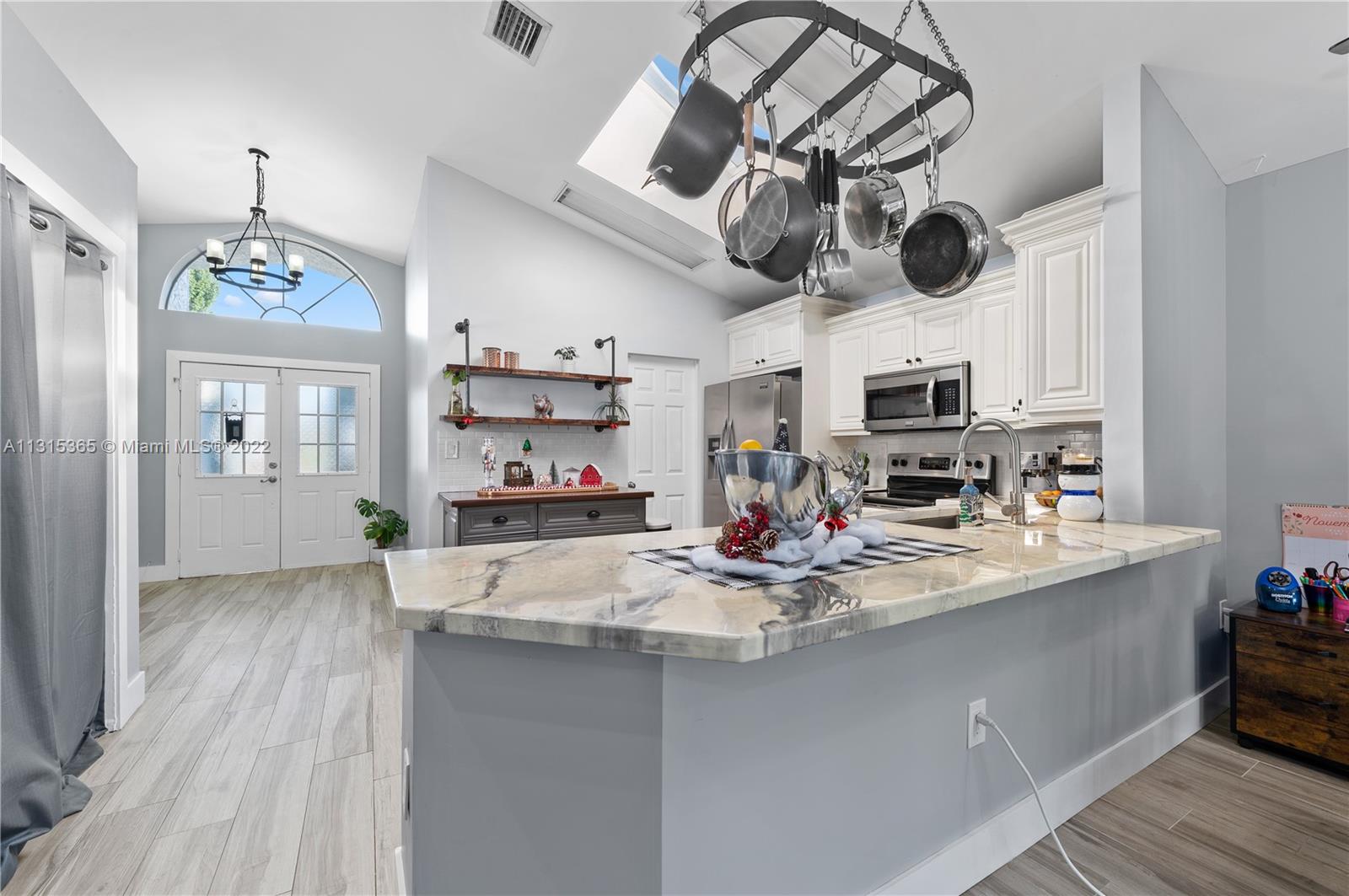 14626 Southwest 128th Court Road Miami, FL 33186 - Photo 4 of 24 a room with stainless steel appliances kitchen island a table and chairs in it