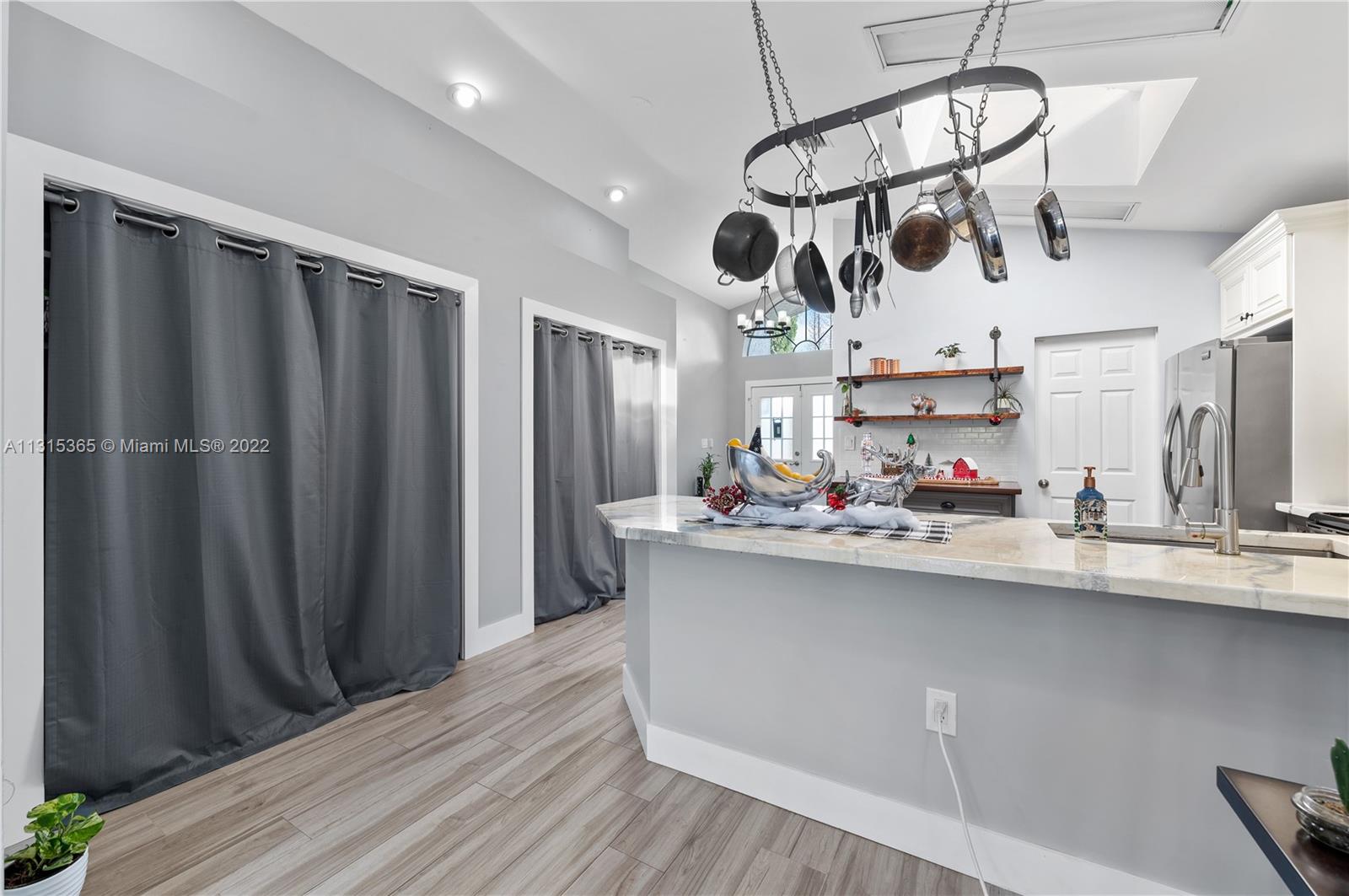 14626 Southwest 128th Court Road Miami, FL 33186 - Photo 7 of 24 a kitchen with stainless steel appliances a wooden floor and cabinets
