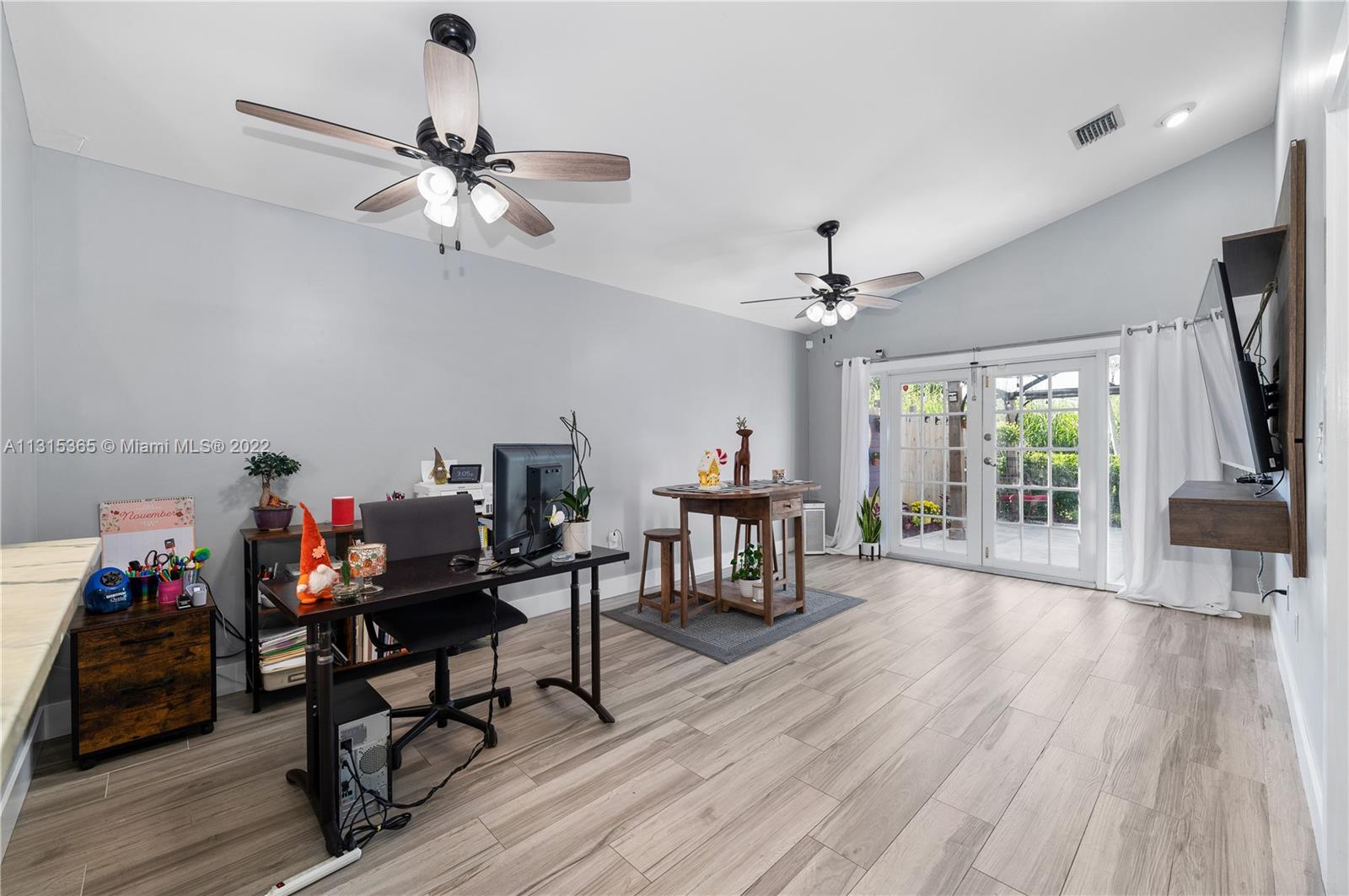 14626 Southwest 128th Court Road Miami, FL 33186 - Photo 9 of 24 a living room with furniture and a flat screen tv