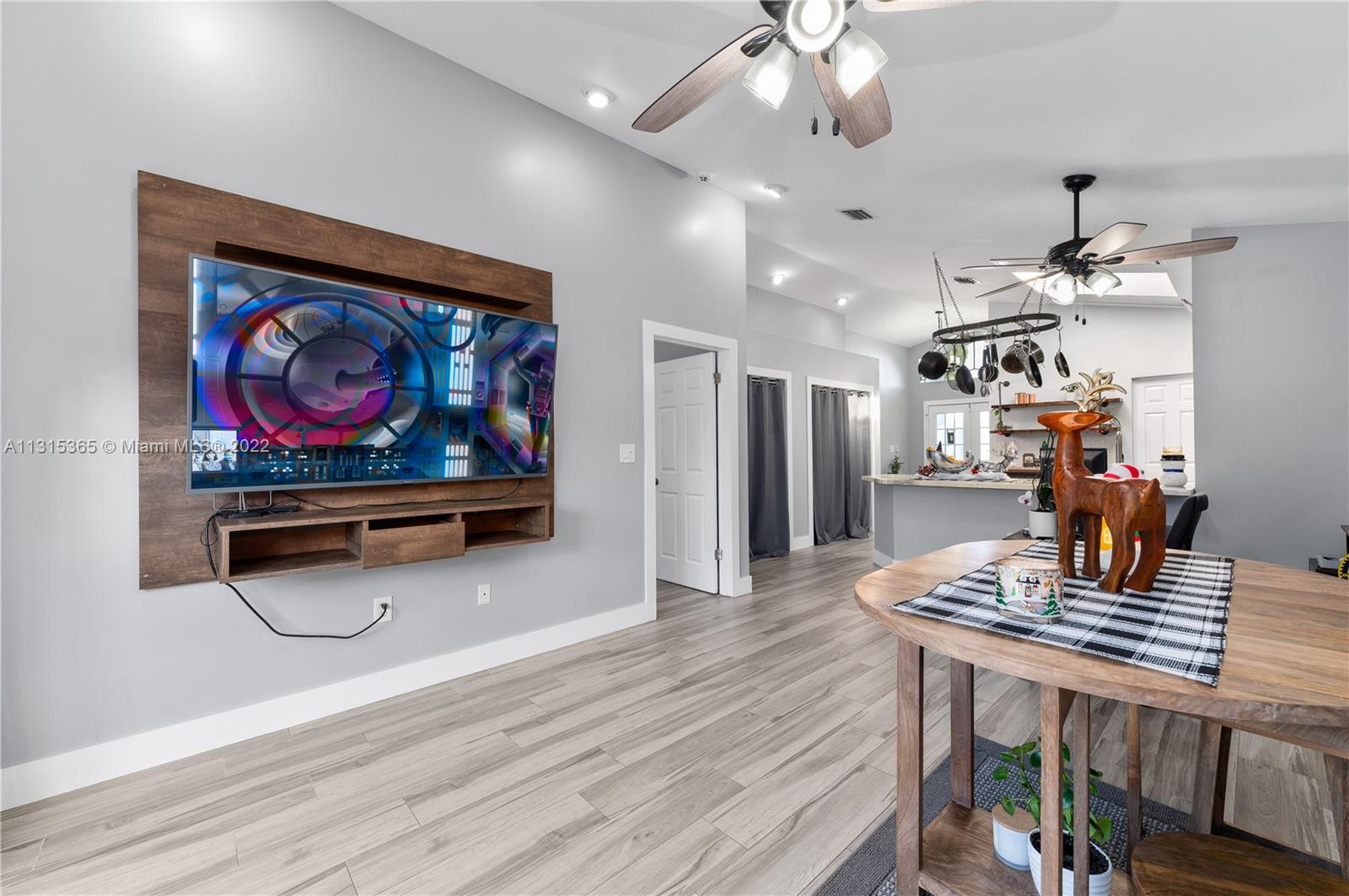 14626 Southwest 128th Court Road Miami, FL 33186 - Photo 10 of 24 a view of a dining room with furniture a chandelier and wooden floor