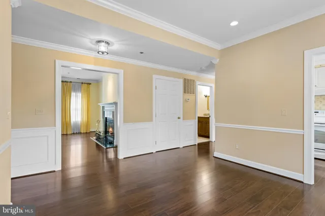 an empty room with wooden floor and a bathroom