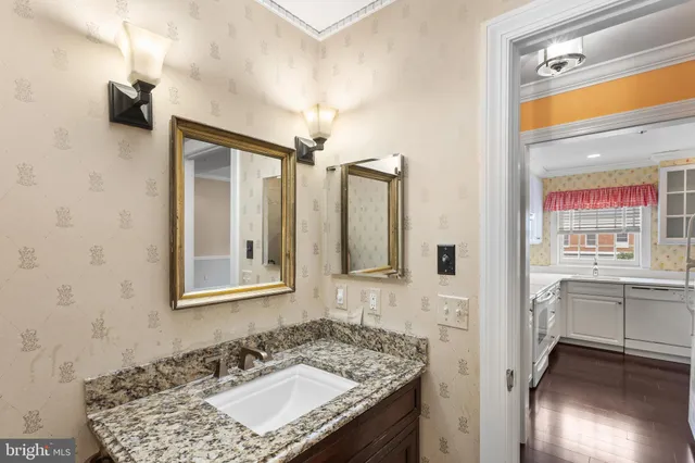 a bathroom with a granite countertop sink and a mirror