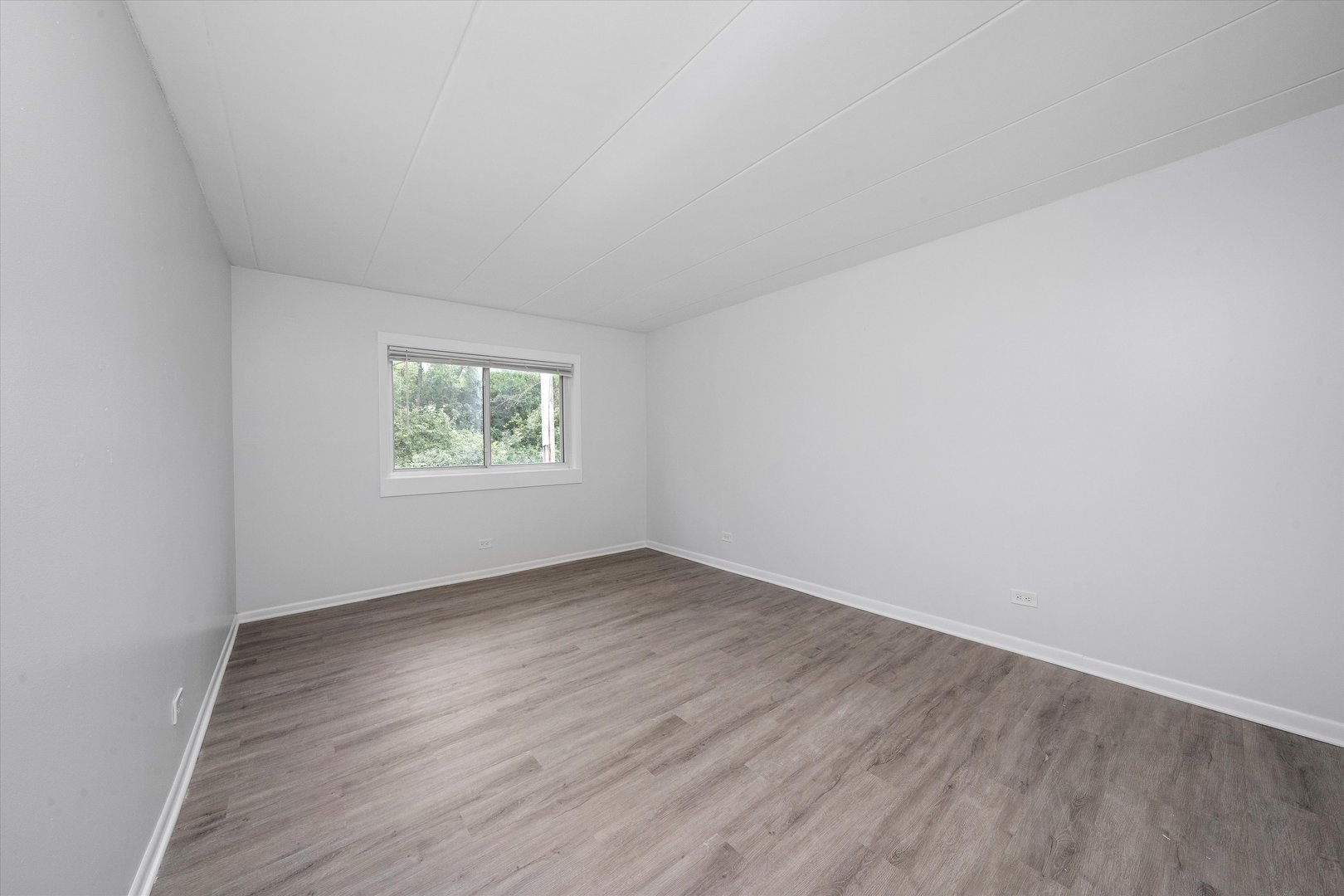 2807 Willow Road, Unit 103 Homewood, IL 60430 - Photo 14 of 21 an empty room with wooden floor and windows