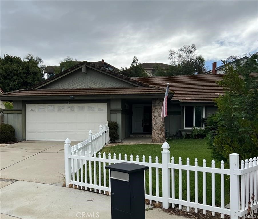 1246 Kinglake Drive Walnut, CA 91789 - Photo 1 of 9 a front view of a house with a garden