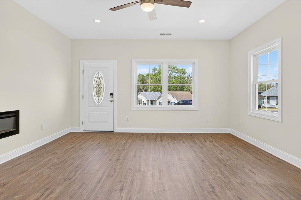 1303 East Main Street Waynesboro, VA 22980 - Photo 12 of 38 an empty room with wooden floor and windows