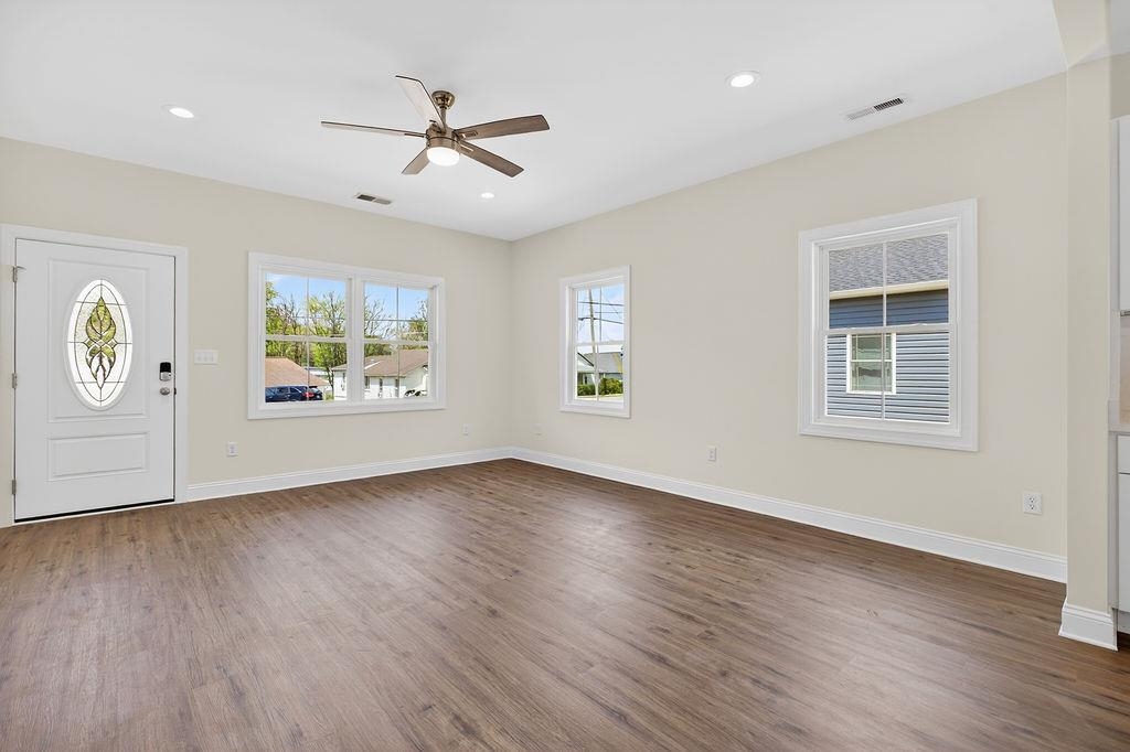 1303 East Main Street Waynesboro, VA 22980 - Photo 13 of 38 a view of an empty room with a window and wooden floor