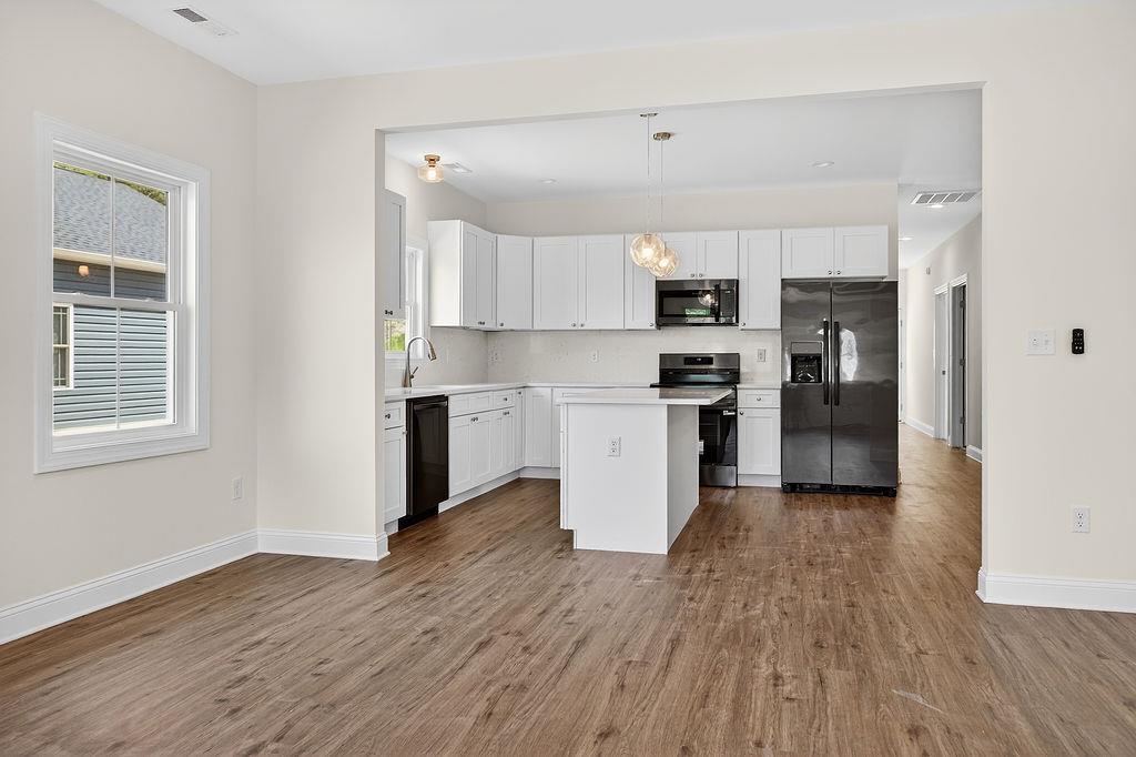 1303 East Main Street Waynesboro, VA 22980 - Photo 20 of 38 a view of kitchen with wooden floor electronic appliances and window