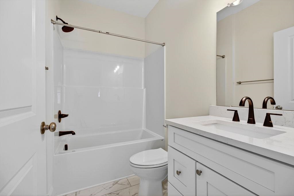 1303 East Main Street Waynesboro, VA 22980 - Photo 34 of 38 a bathroom with a sink a toilet and a bathtub