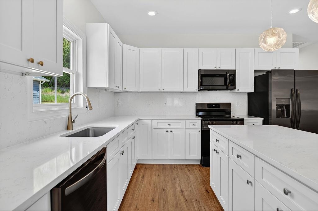 1303 East Main Street Waynesboro, VA 22980 - Photo 7 of 38 a kitchen with white cabinets stainless steel appliances and sink