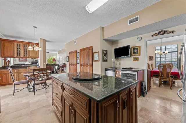 a view of a dining room with furniture large windows and outside view