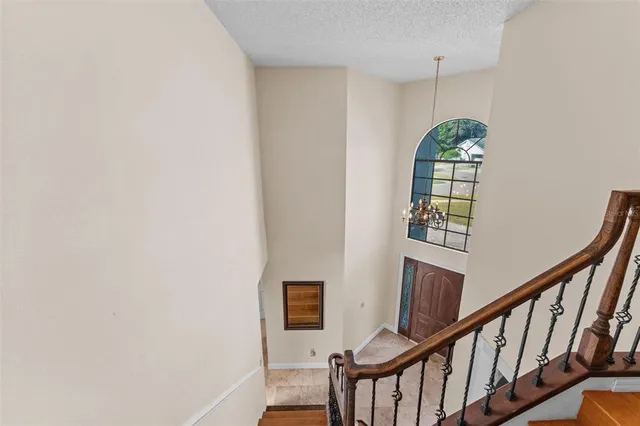 a spacious bedroom with a bed and wooden floor