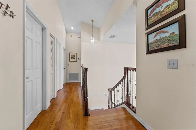 a bedroom with a bed chandelier and a couch