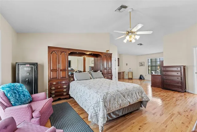 a bedroom with furniture and baby crib
