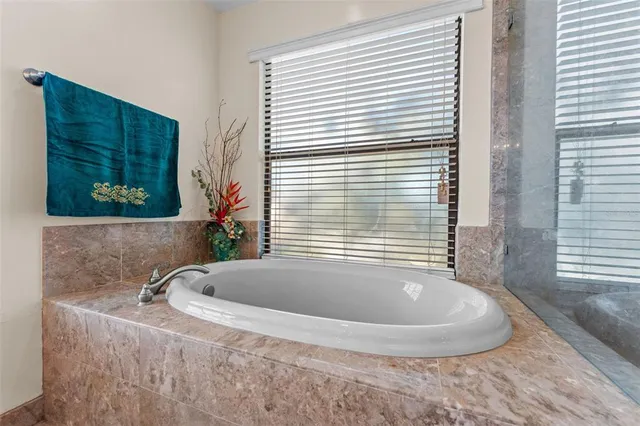 a bathroom with a sink toilet double vanity and shower