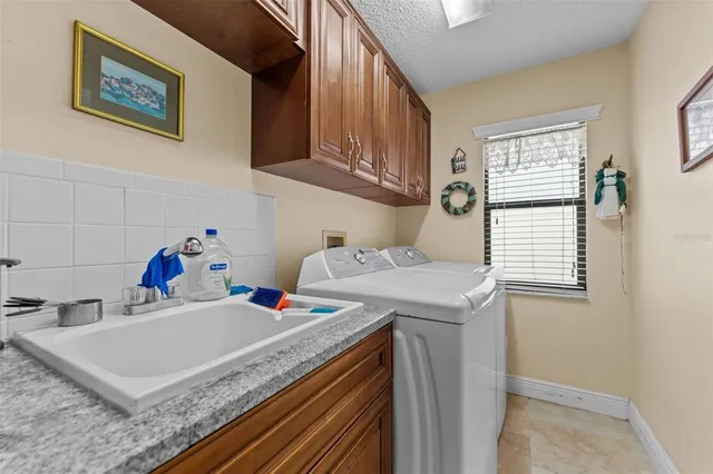 an aerial view of residential house with outdoor space and trees all around