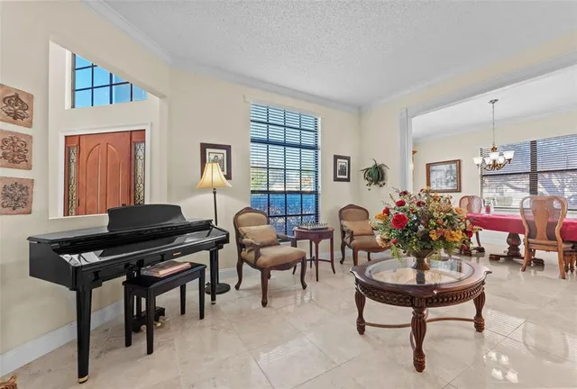 a living room with furniture and a dining table with rug