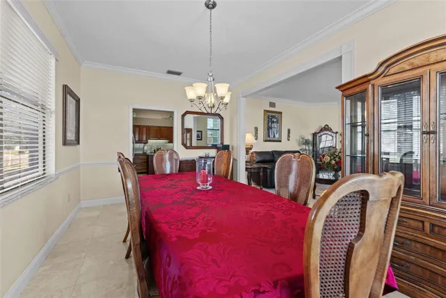 a kitchen with granite countertop wooden cabinets a dining table and chairs