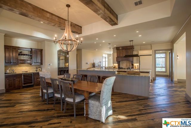 a living room with patio furniture and a large window