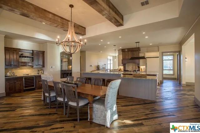 a living room with patio furniture and a large window