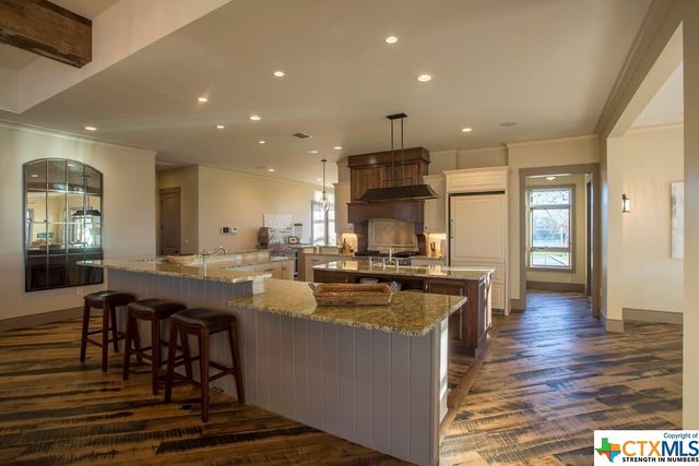 a bedroom with a bed a flat screen tv and a large window