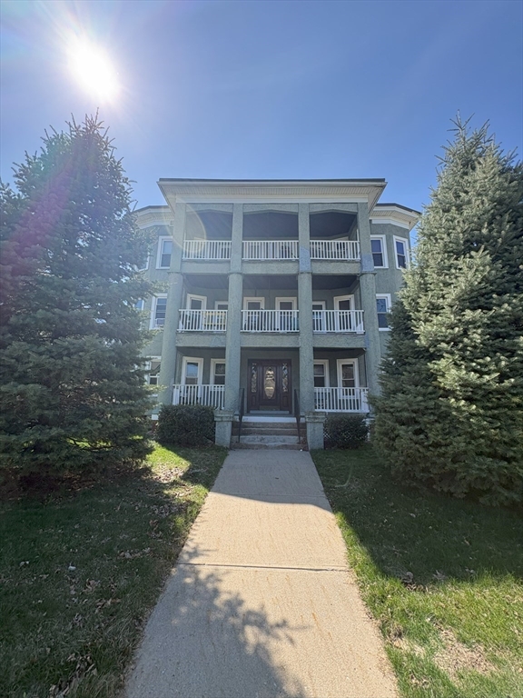 356 Springfield Street, Unit 1 Chicopee, MA 01013 - Photo 8 of 10 a front view of a building with a garden