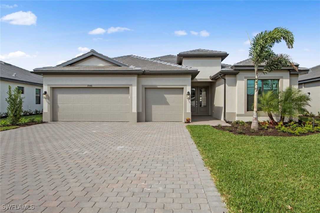 a front view of a house with a garden and plants