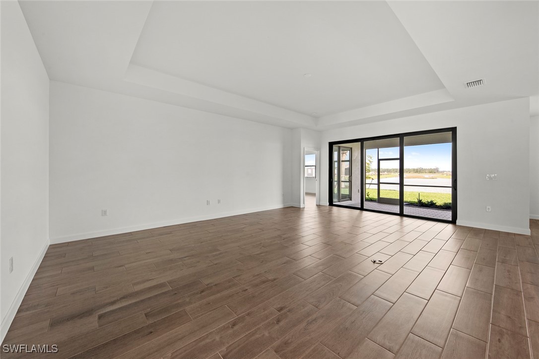 20446 Napa Loop Estero, FL 33928 - Photo 14 of 42 wooden floor in an empty room with a window