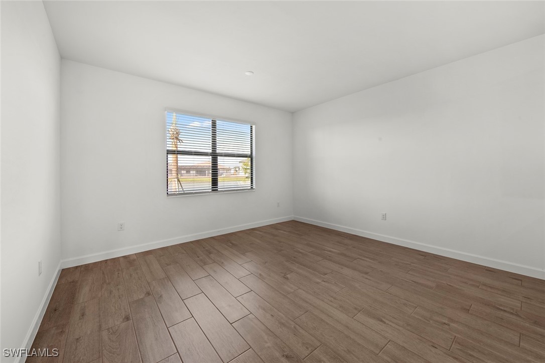 20446 Napa Loop Estero, FL 33928 - Photo 18 of 42 an empty room with wooden floor and windows