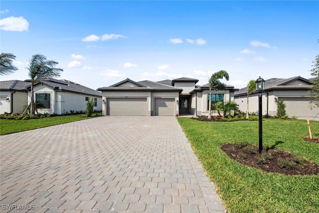 20446 Napa Loop Estero, FL 33928 - Photo 2 of 42 a front view of a house with a yard and garage