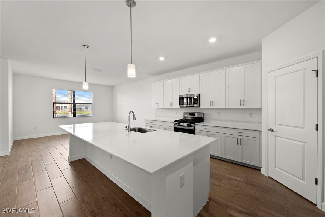 20446 Napa Loop Estero, FL 33928 - Photo 23 of 42 a kitchen with sink cabinets and wooden floor