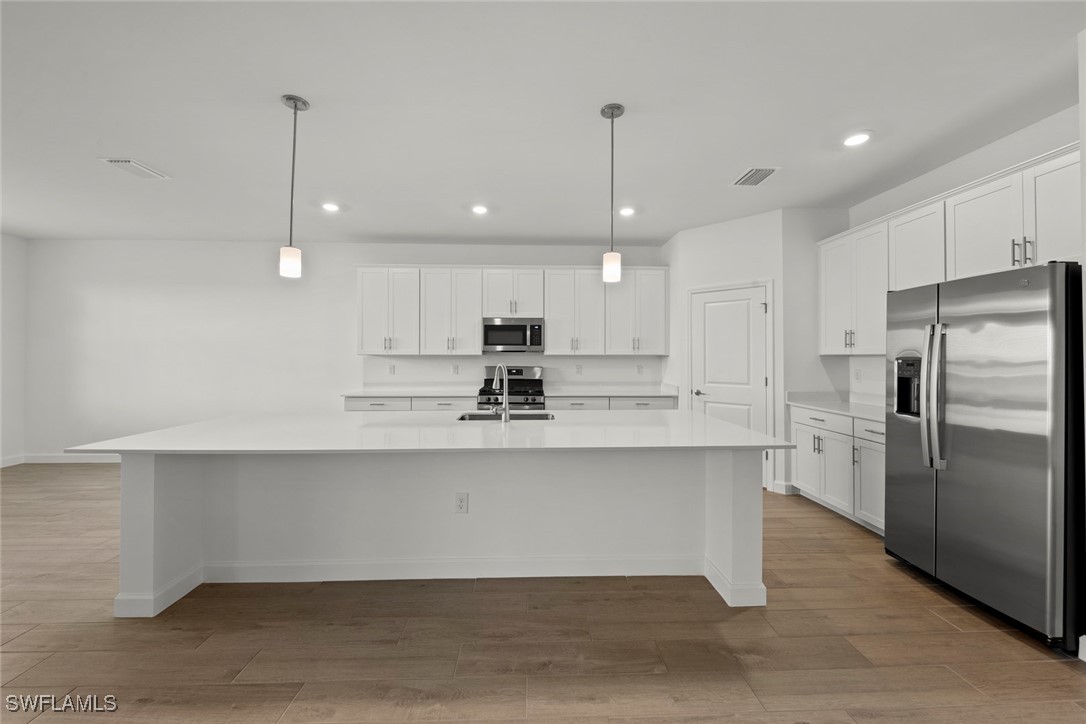 20446 Napa Loop Estero, FL 33928 - Photo 24 of 42 a kitchen with stainless steel appliances granite countertop a refrigerator a sink and a oven