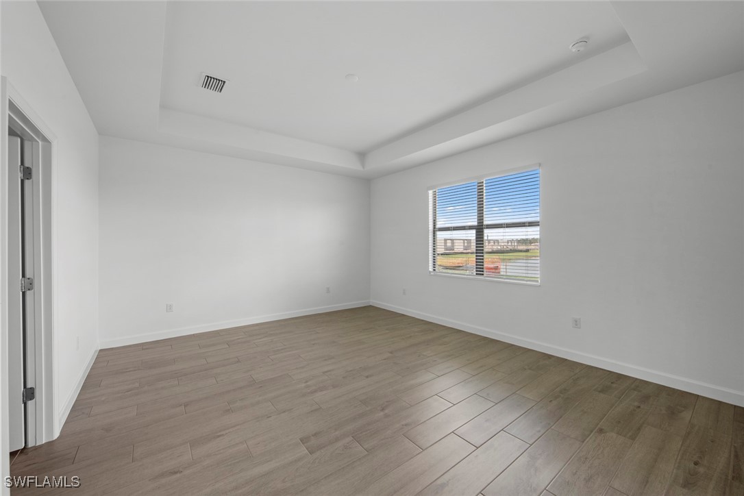 20446 Napa Loop Estero, FL 33928 - Photo 25 of 42 an empty room with wooden floor and windows