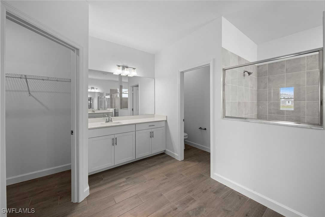 20446 Napa Loop Estero, FL 33928 - Photo 30 of 42 a bathroom with a granite countertop sink mirror and a toilet