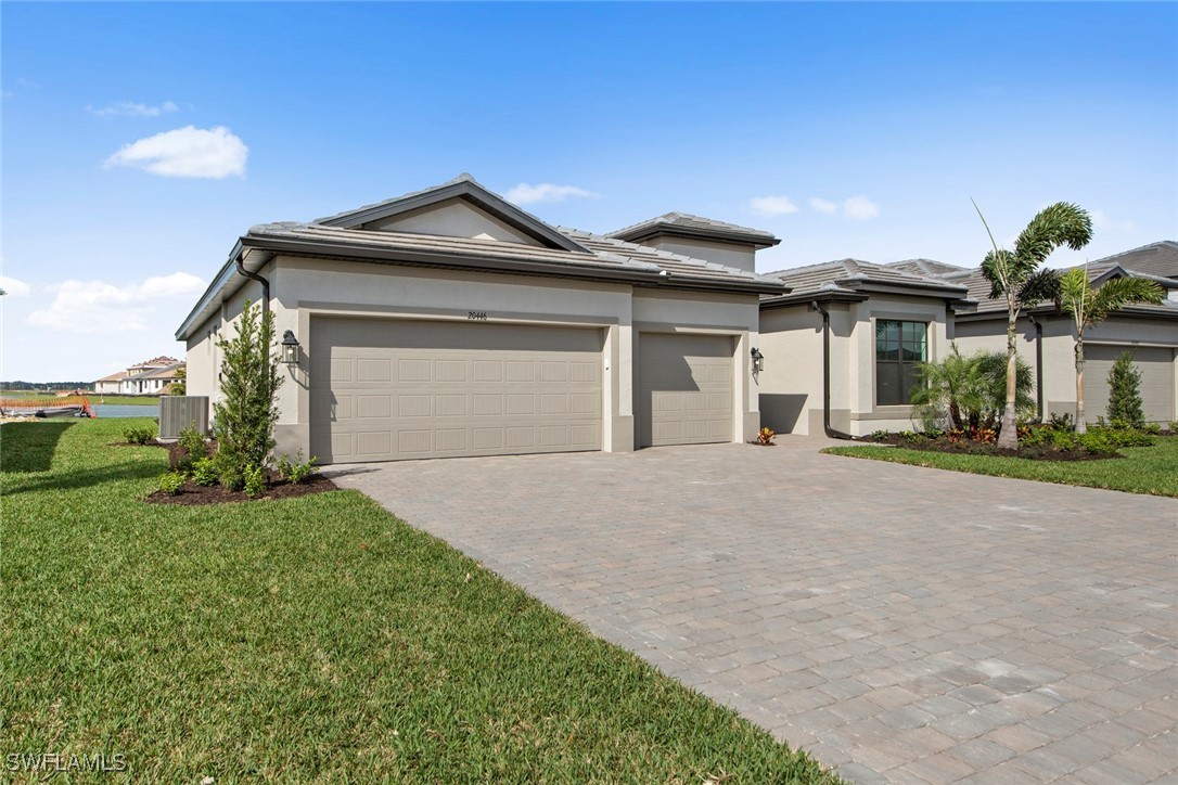 20446 Napa Loop Estero, FL 33928 - Photo 3 of 42 a front view of a house with a yard and garage