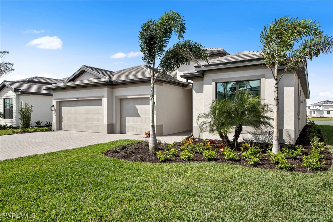 20446 Napa Loop Estero, FL 33928 - Photo 4 of 42 a front view of a house with a yard and garage