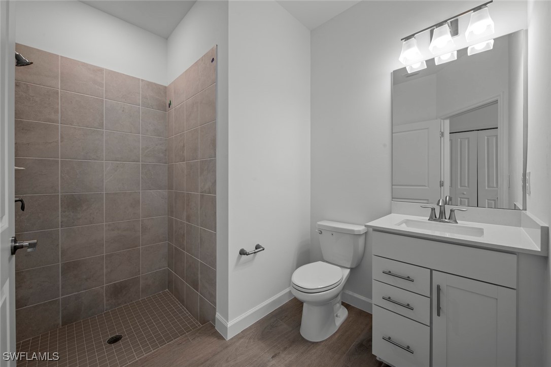 20446 Napa Loop Estero, FL 33928 - Photo 41 of 42 a bathroom with a toilet sink vanity and granite